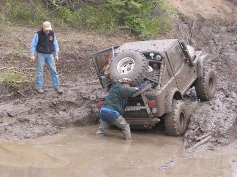 1985 Ford Bronco - Wayne (From Arctic offroad) Getting at Greg's tree saver strap to get him out of the pit.