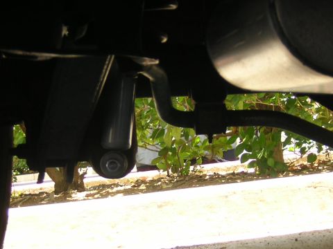 1992 Ford Crown Victoria - Underside view of a vehicle's suspension system, showing a shock absorber and sway bar.