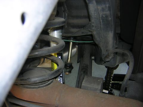 1992 Ford Crown Victoria - Close-up view of a rear suspension stabilizer bar link, part of the car's undercarriage.