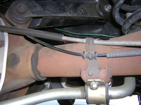 1992 Ford Crown Victoria - Underside view of a 1992 Ford Crown Victoria's rear axle and suspension system, exhibiting signs of wear and tear.