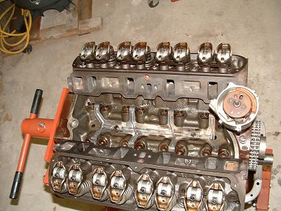 1985 Ford LTD Crown Victoria - V8 engine block with rocker arms and distributor visible, mounted on an engine stand.