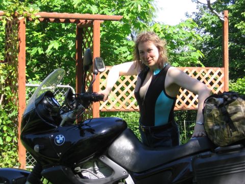 1979 Ford Bronco - Woman poses with a motorcycle in a backyard setting.