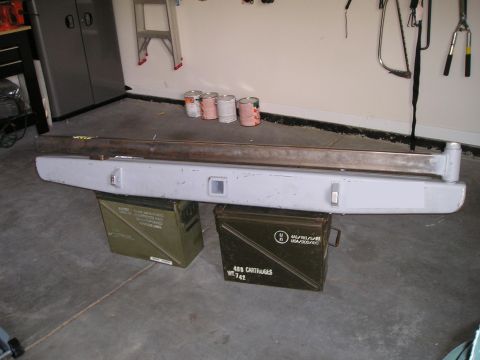 1996 Ford Bronco - Ford Bronco rear bumper and two ammo cans are displayed in a garage.