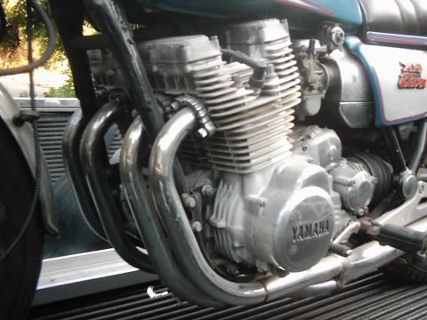 1978 Ford Bronco - Close-up view of a motorcycle engine, showing its exhaust system and branding.