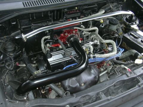 1991 Ford Festiva - Engine bay details, including aftermarket intake and strut bar, with red engine component accents.