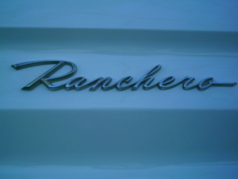 Chrome Ranchero emblem on a light blue vehicle panel