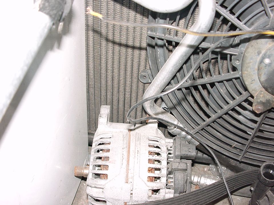 Close-up of car's alternator and cooling fan assembly