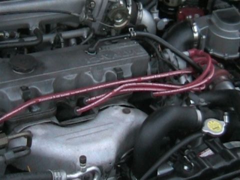1989 Mazda MX-6 - Close-up view of an engine bay, showing various components and wiring.