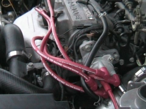 1989 Mazda MX-6 - Close-up of a Mazda engine, red Magnecor R-100 Racing spark plug wires.