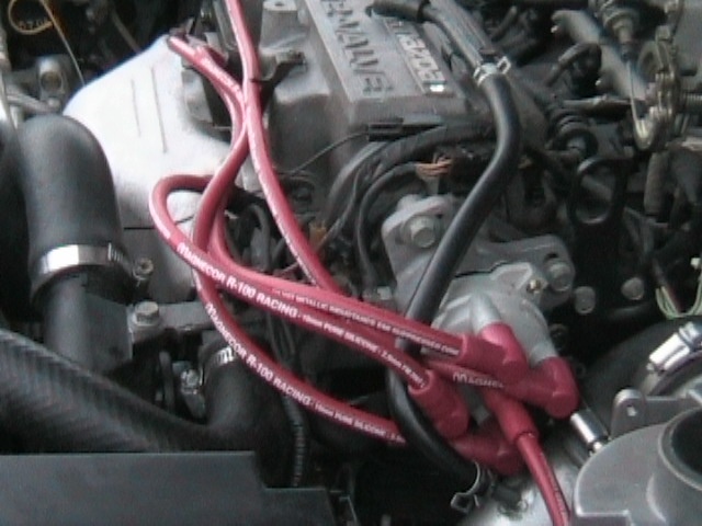 Red Magnecor R-100 Racing plug wires on a 16-valve engine's distributor