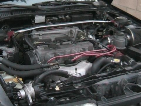1989 Mazda MX-6 - Close-up view of the engine compartment, showing the engine and surrounding components.