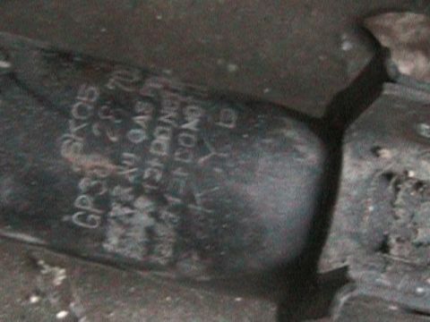 1989 Mazda MX-6 - Part with stamped text including 'GP304 SK05' and '23.8 GAU GAS'.