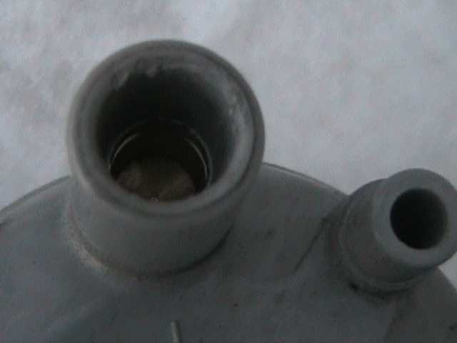 Close-up of a metal vehicle part with two openings