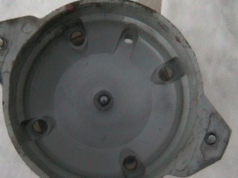 1989 Mazda MX-6 - This is a close-up view of the interior of a vehicle's distributor cap, showing the contact points and central rotor connection.