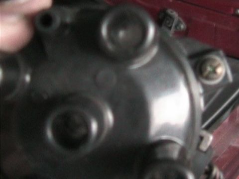 1989 Mazda MX-6 - A close-up view of a vehicle's distributor cap, showing its intricate internal components.
