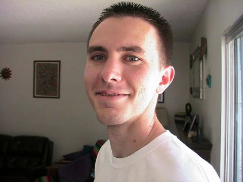 1993 Ford Taurus - A man is pictured indoors, smiling at the camera.