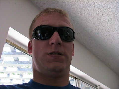 1993 Ford Taurus - A man wearing black sunglasses is seen from the chest up, indoors.