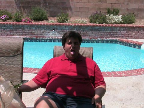 1993 Ford Taurus - A person sits by a swimming pool on a sunny day.