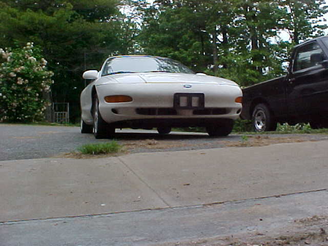 1994 Ford Probe front view, white coupe parked next to black truck