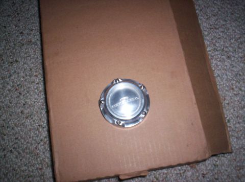 1989 Ford Bronco II - A Cragar center cap rests on a piece of cardboard.