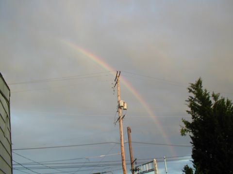 1979 Ford Bronco - A double rainbow appears in the sky after a storm, with a telephone pole and wires in the foreground.