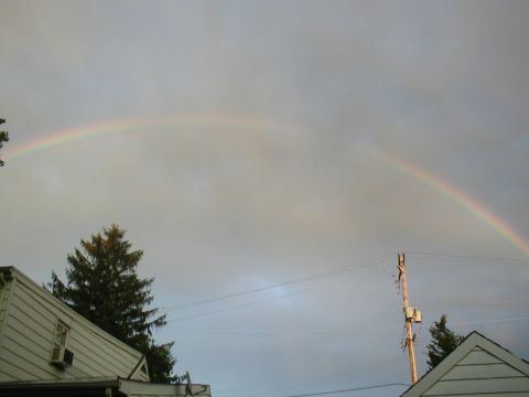1979 Ford Bronco - A rainbow appears in the sky above houses and a utility pole.
