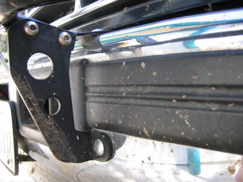 1995 Ford Bronco - This is a close-up view of a vehicle's front bumper and an attached bracket, showing mud splatter.