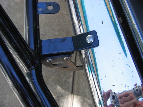 1995 Ford Bronco - Close-up of chrome bumper and black metal brackets, with "SUPERMOTORS" text visible.