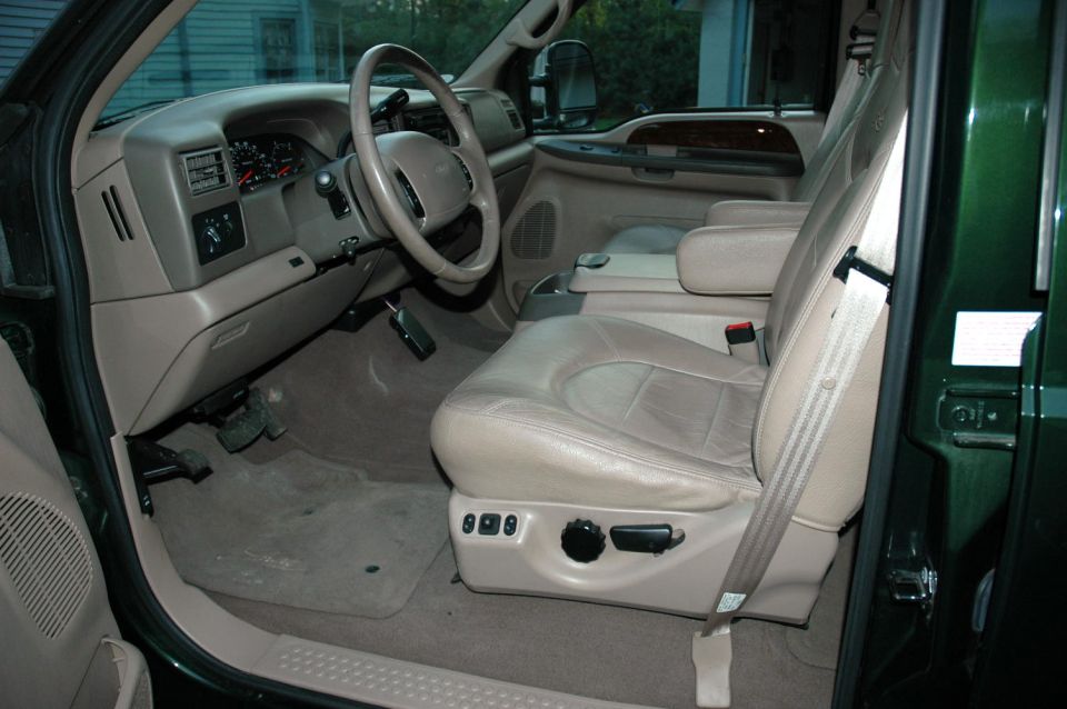Tan leather interior of a Ford Super Duty truck viewed through the open driver's door