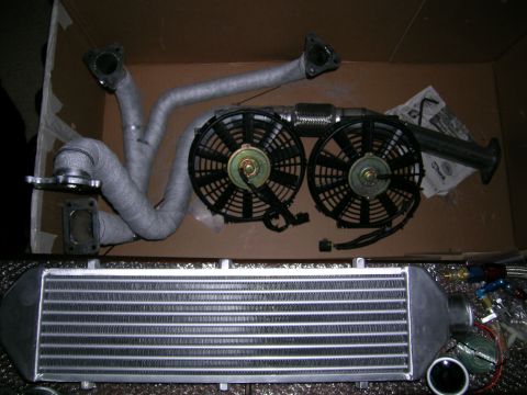 1994 Ford Probe - Aftermarket turbocharger manifold, electric fans, and intercooler kit shown in a box.