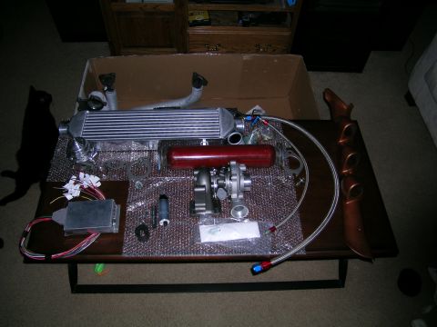 1994 Ford Probe - Various automotive turbocharger components are arranged on a table, ready for installation.