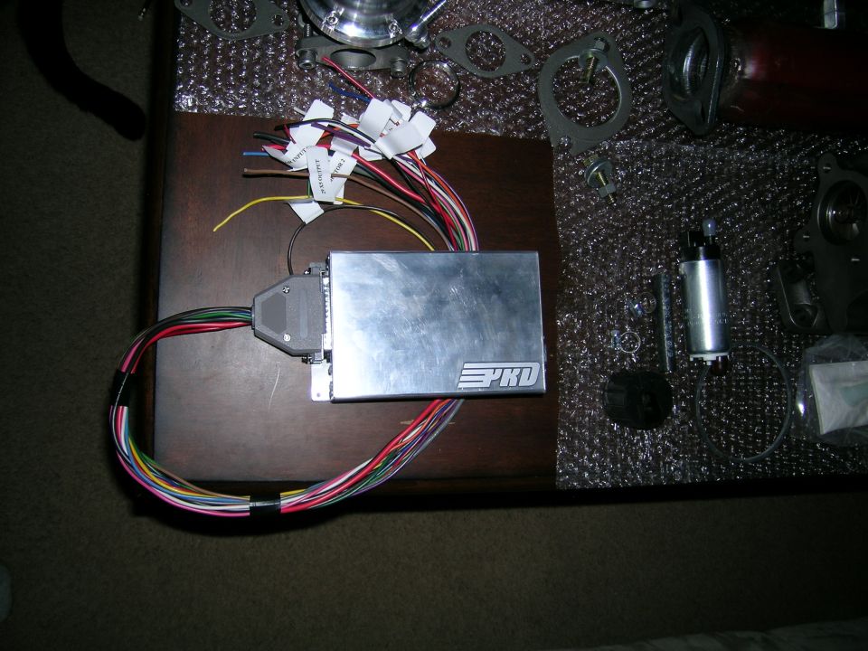 Engine control unit with wiring harness and fuel pump assembly