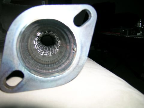 1994 Ford Probe - Close-up view of an exhaust pipe's internal baffle and mounting flange.