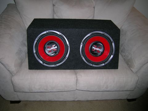 1994 Ford Probe - Dual Sony Xplod subwoofers are shown in their enclosure, placed on a couch.