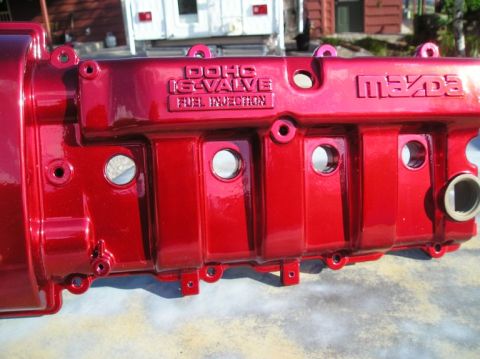 1994 Ford Probe - A red painted Mazda engine valve cover with DOHC 16-valve Fuel Injection text is shown.