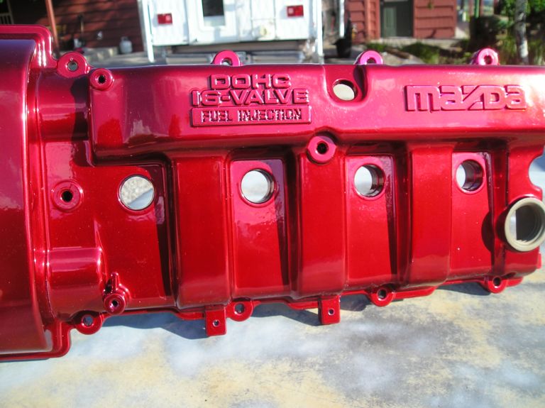 Red painted Mazda DOHC 16-valve fuel injection valve cover, close-up
