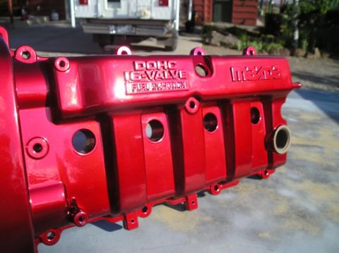 1994 Ford Probe - Close-up of a red engine valve cover with DOHC 16-Valve Fuel Injection and Mazda branding visible.