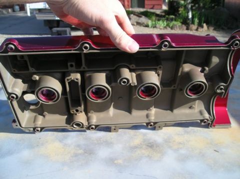 1994 Ford Probe - Close-up of an engine valve cover, showing internal components and red painted exterior.