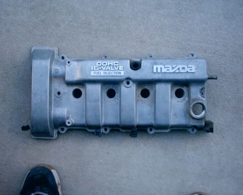 1994 Ford Probe - Silver engine valve cover with Mazda branding and DOHC 16-valve Fuel Injection text.
