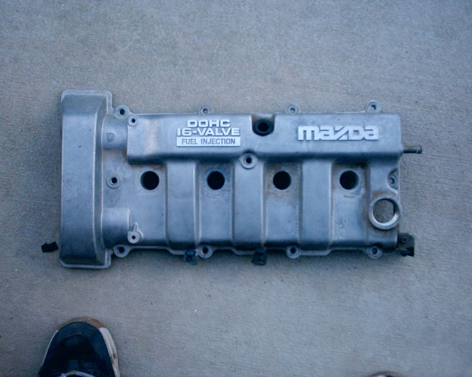 Silver Mazda DOHC 16-valve fuel injection engine valve cover