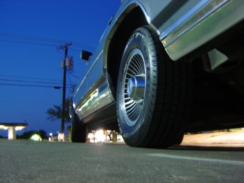 1988 Ford Crown Victoria LTD - Low angle shot of a 1988 Ford Crown Victoria LTD's wheel and side panel.