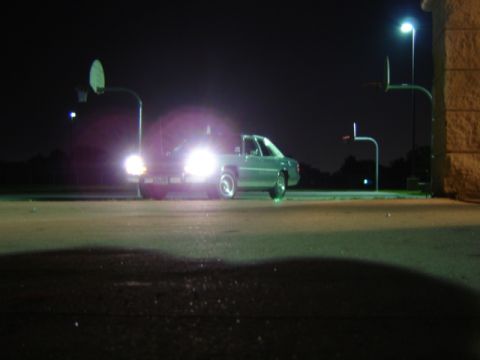 1988 Ford Crown Victoria LTD - A 1988 Ford Crown Victoria LTD is parked at night, illuminated by its own headlights and nearby streetlights.