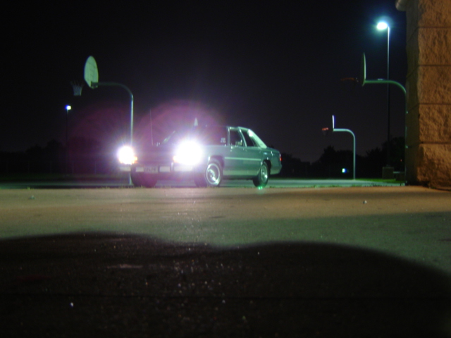 1988 Ford Crown Victoria LTD parked at night under streetlights, headlights on
