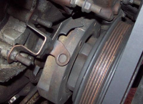1985 Ford Crown Victoria LTD - This image shows a close-up view of a vehicle's engine pulley system and a belt.