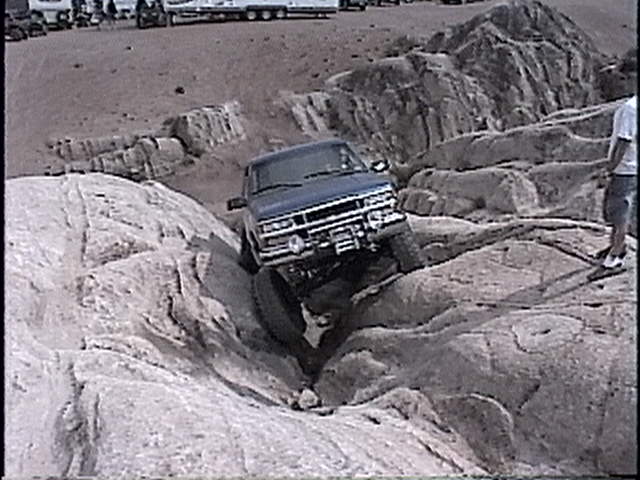 Blue 1997 Chevrolet C/K Pickup navigating rocky terrain