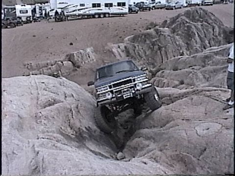 1997 Chevrolet C/K Pickup - Chevrolet C/K Pickup is shown off-roading over large rocks.