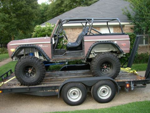 1995 Ford Bronco - This 1974 Ford Bronco is shown on a trailer with a roll cage and large off-road tires.
