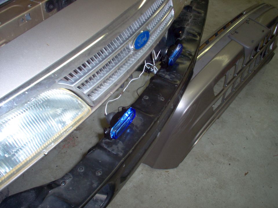 These cheap lights are easy to mount & aim.  In this location, it will also be easy to change the bulbs by reaching up thru the bumper skin.