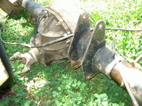 1985 Ford Bronco - A rear axle assembly, likely from a truck or SUV, is shown lying on the ground.