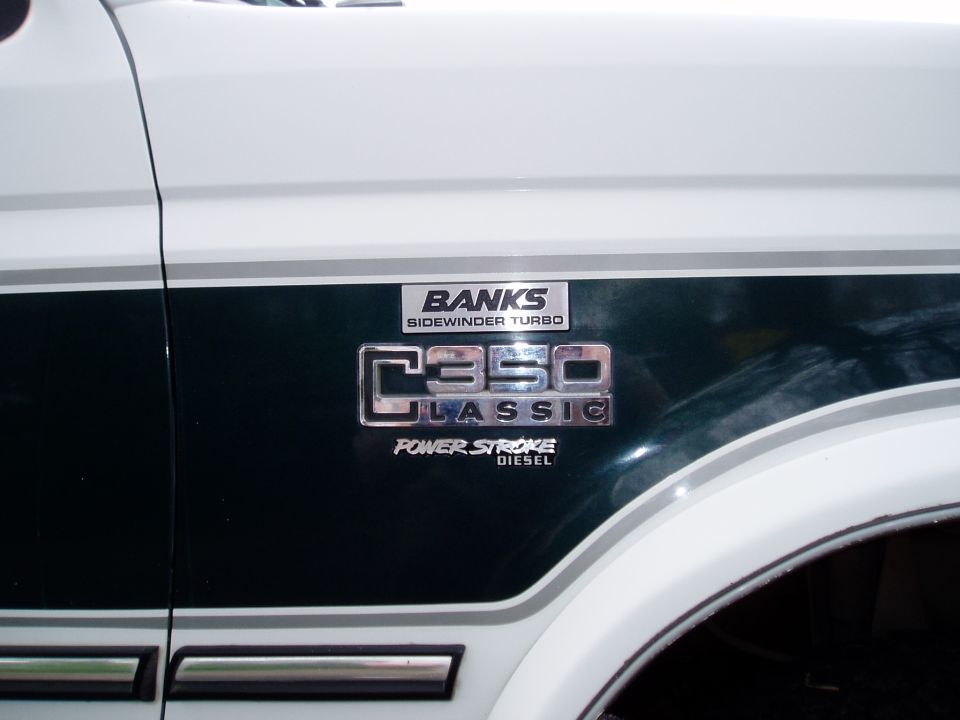 White truck body panel with C350 Classic, Banks Sidewinder Turbo, and Power Stroke Diesel badges